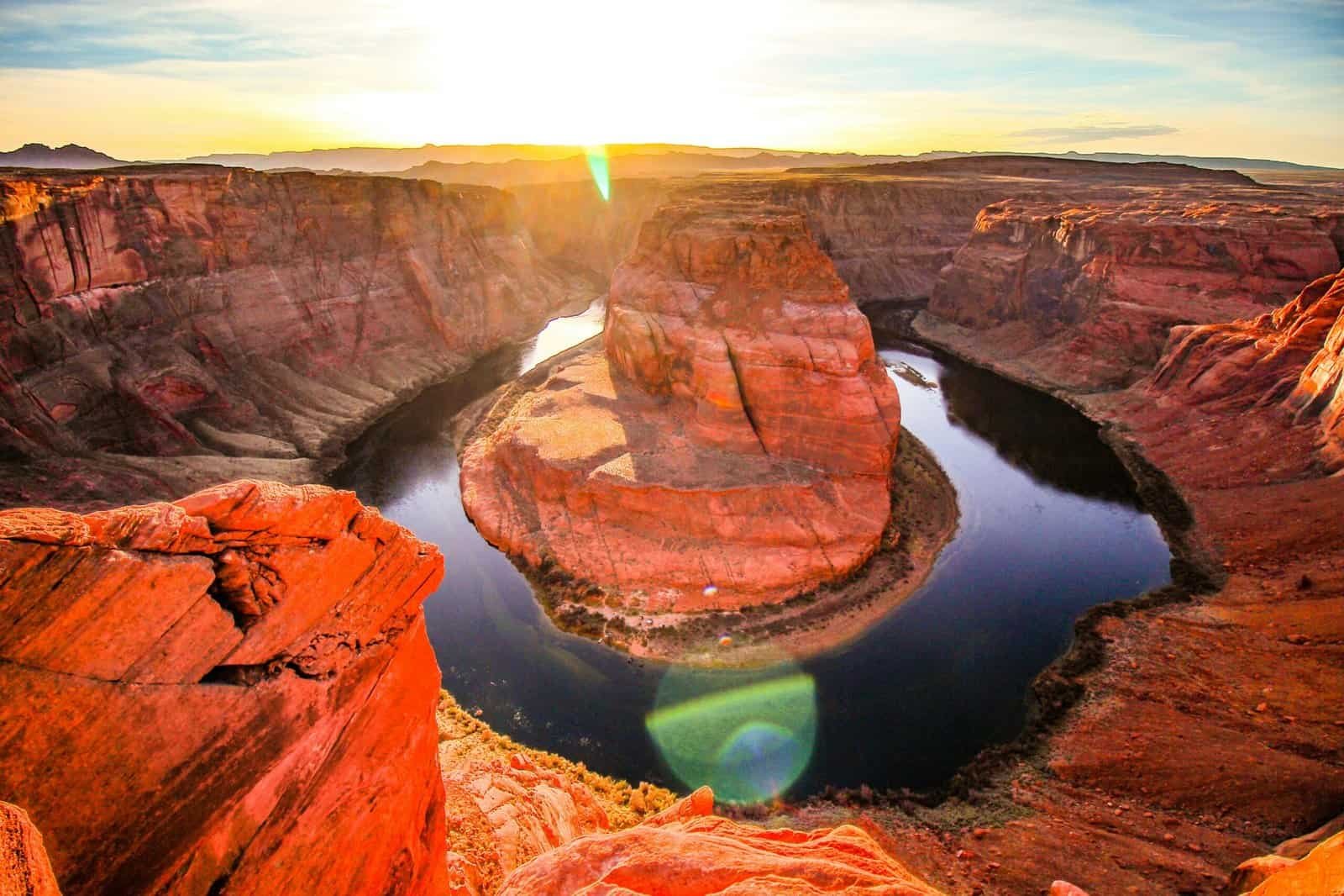 Sunrise view of Horseshoe Bend, where the Colorado River curves around towering red sandstone cliffs—an iconic natural landmark and one of the best vacation sites in the USA.